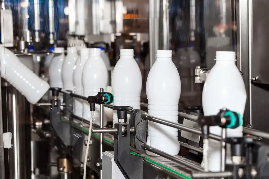 milk bottle filled and packaged by machine